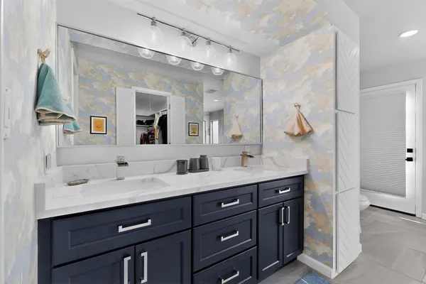 a bathroom with a double vanity sink and a mirror