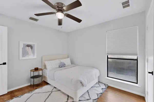 a bedroom with a bed and a painting on the wall