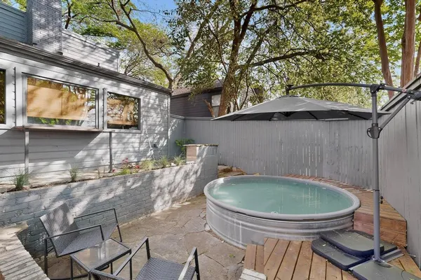 a view of a chairs and table in backyard
