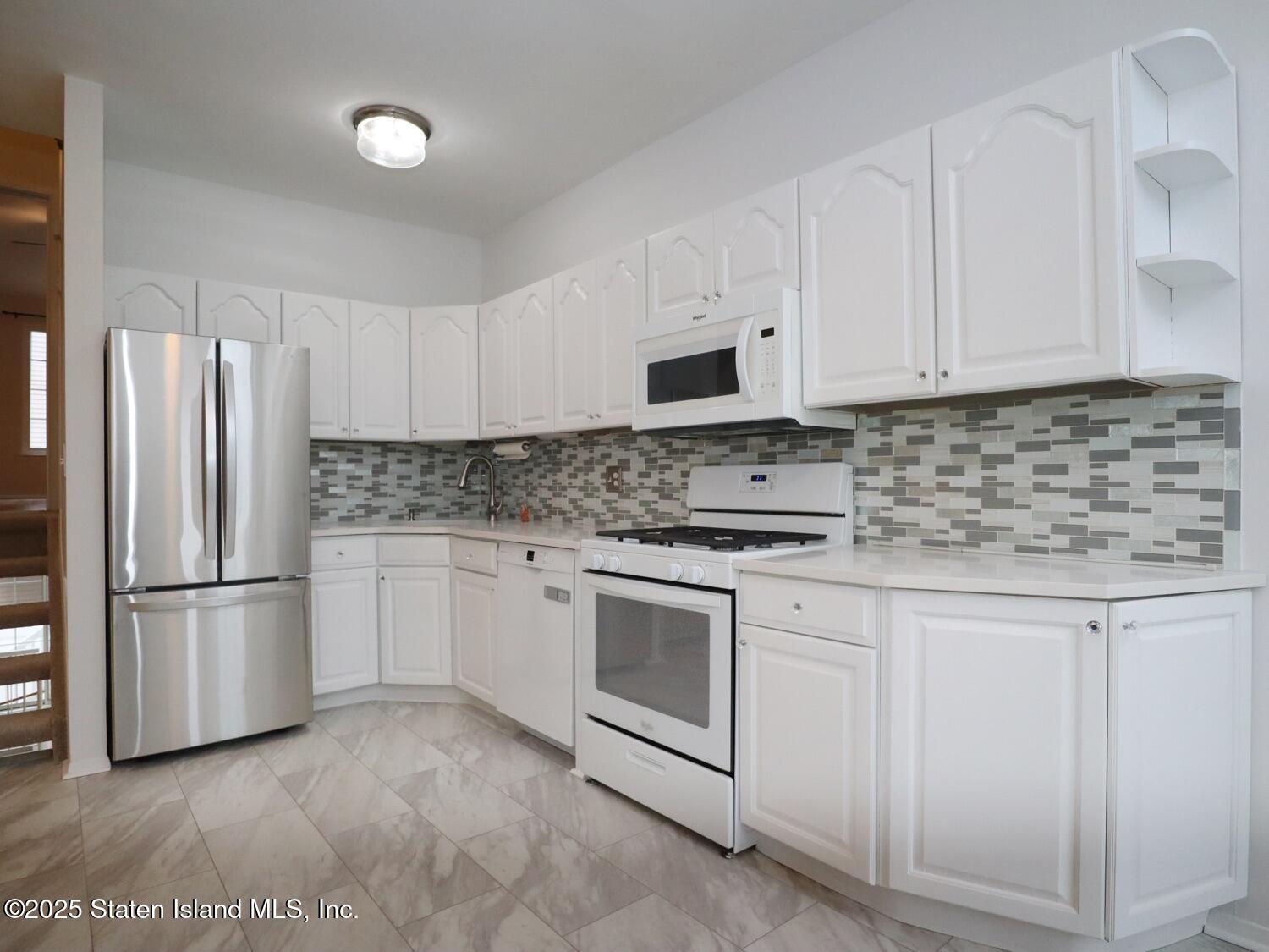75 Chesebrough Street Staten Island, NY 10312 - Photo 11 of 32 a kitchen with appliances a sink and cabinets