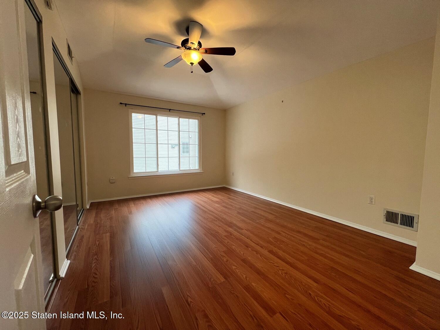 75 Chesebrough Street Staten Island, NY 10312 - Photo 14 of 32 an empty room with wooden floor and windows