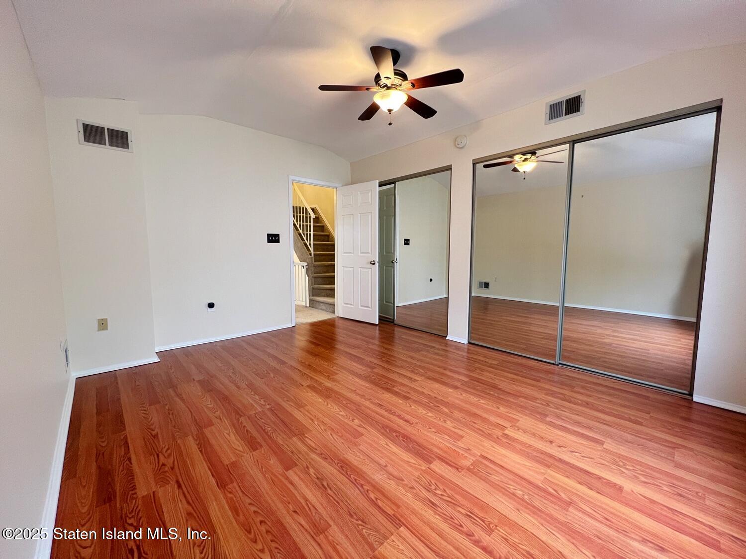 75 Chesebrough Street Staten Island, NY 10312 - Photo 16 of 32 a view of empty room with wooden floor and fan