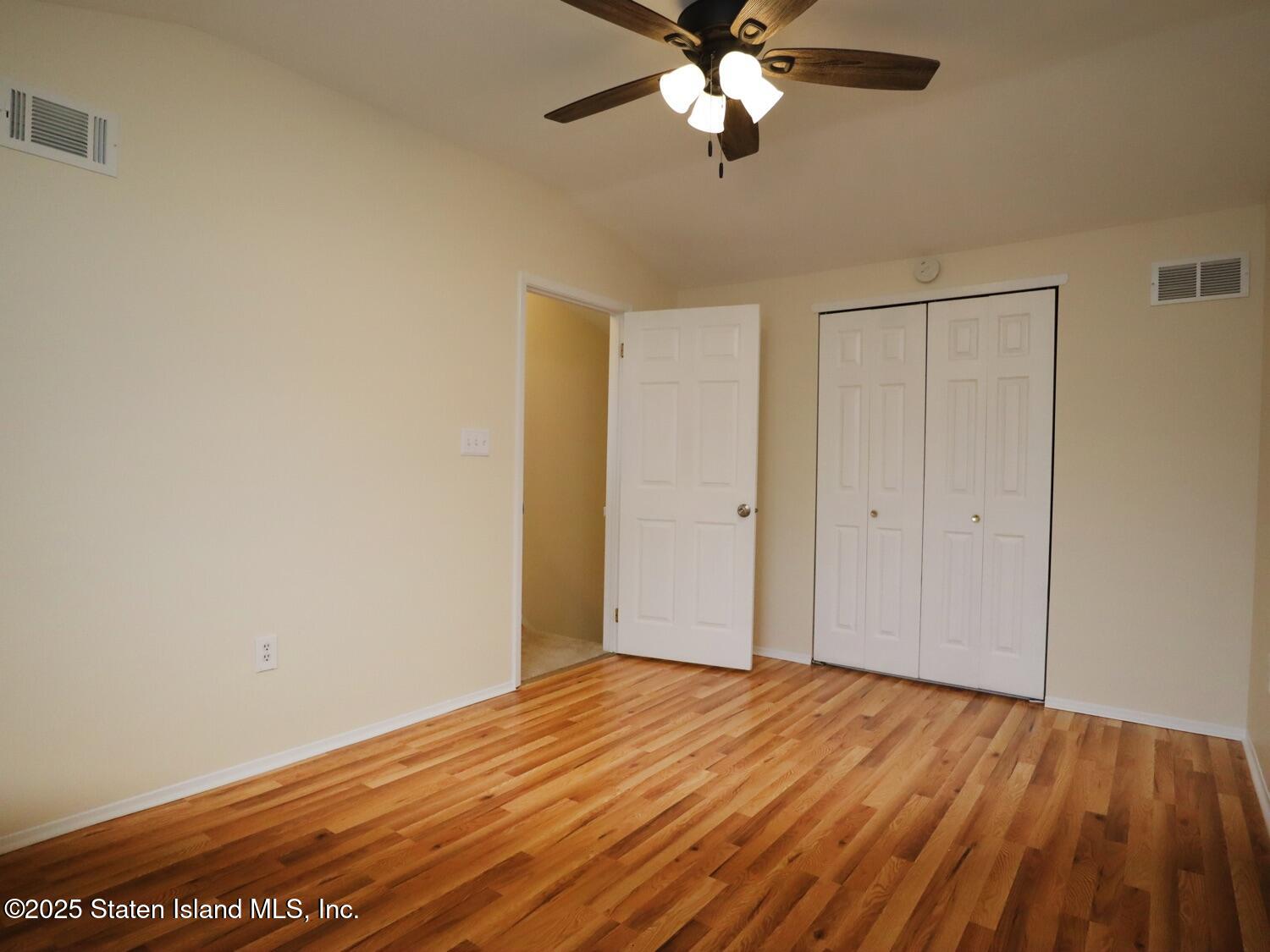 75 Chesebrough Street Staten Island, NY 10312 - Photo 19 of 32 a view of an empty room with wooden floor