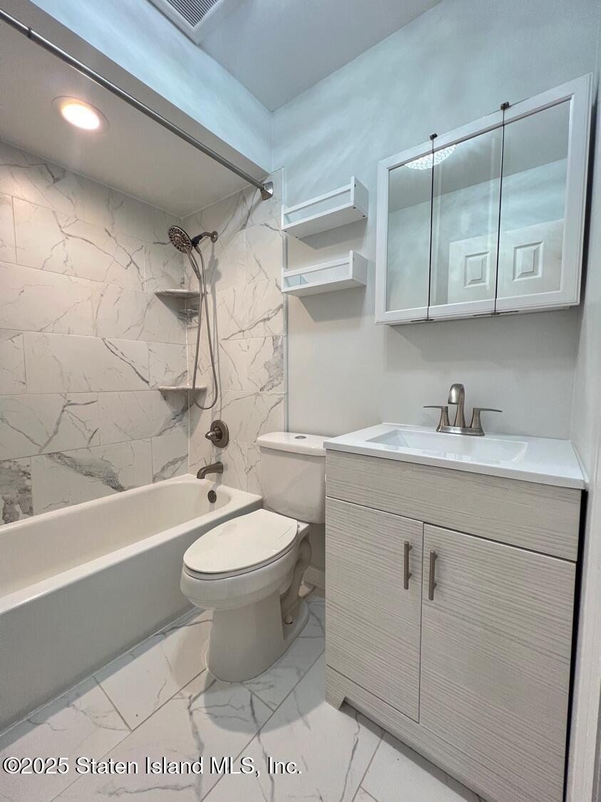 75 Chesebrough Street Staten Island, NY 10312 - Photo 22 of 32 a bathroom with a sink a toilet and shower
