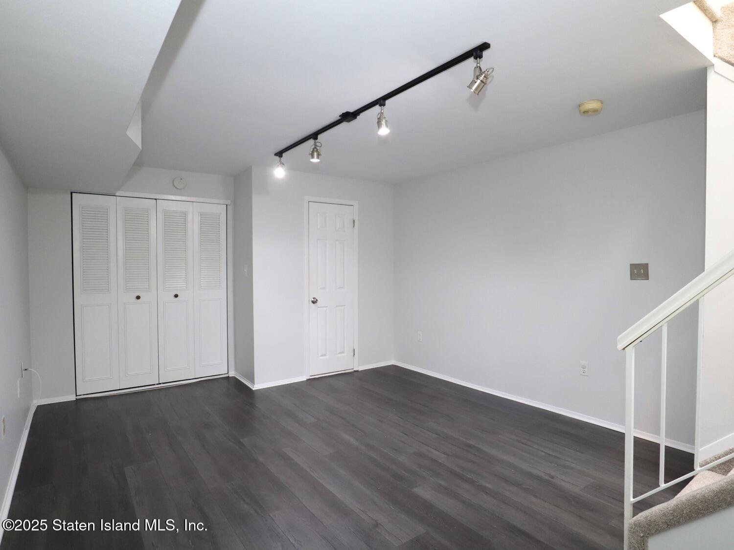 75 Chesebrough Street Staten Island, NY 10312 - Photo 23 of 32 a view of an empty room with wooden floor