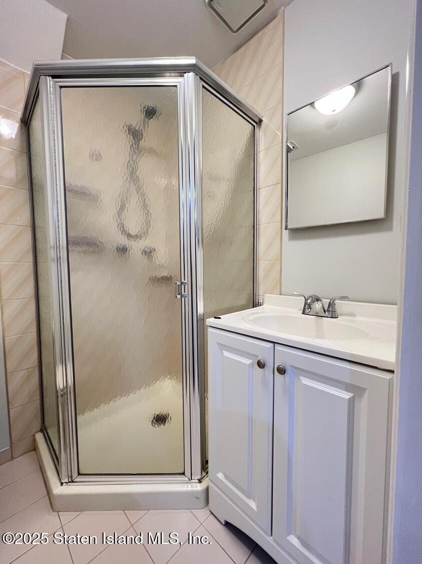75 Chesebrough Street Staten Island, NY 10312 - Photo 25 of 32 a bathroom with a shower sink and mirror