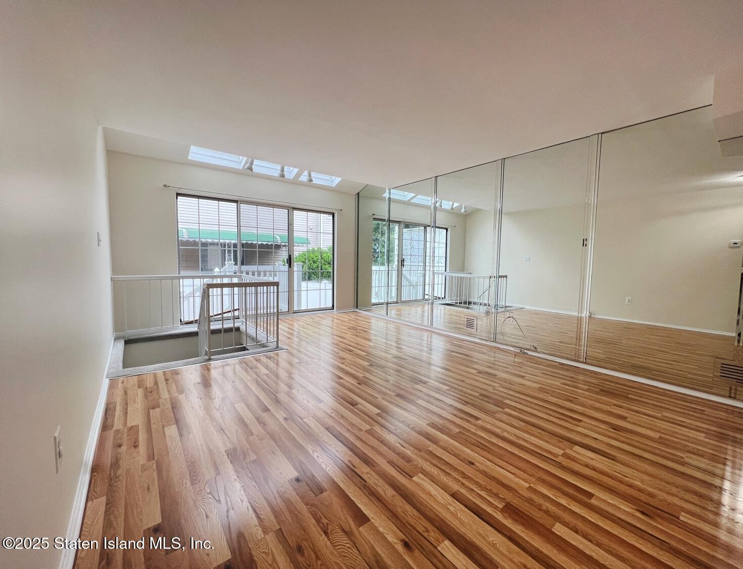75 Chesebrough Street Staten Island, NY 10312 - Photo 3 of 32 a view of empty room with wooden floor and fan