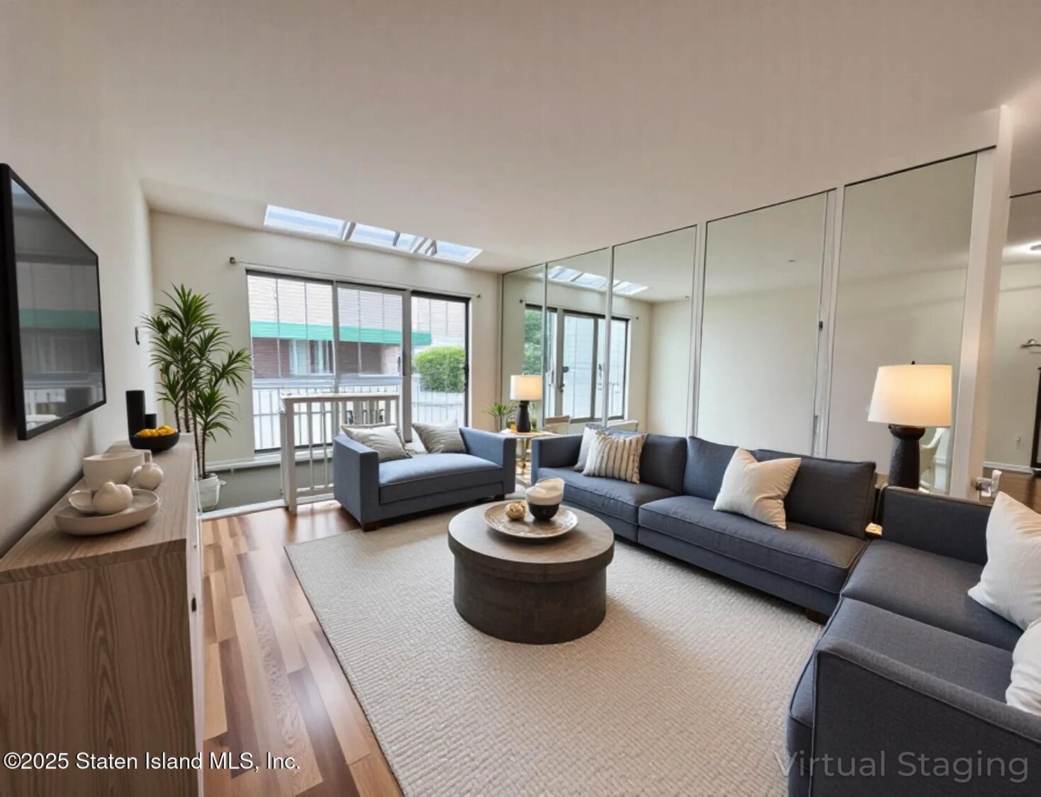 75 Chesebrough Street Staten Island, NY 10312 - Photo 4 of 32 a living room with furniture and a flat screen tv