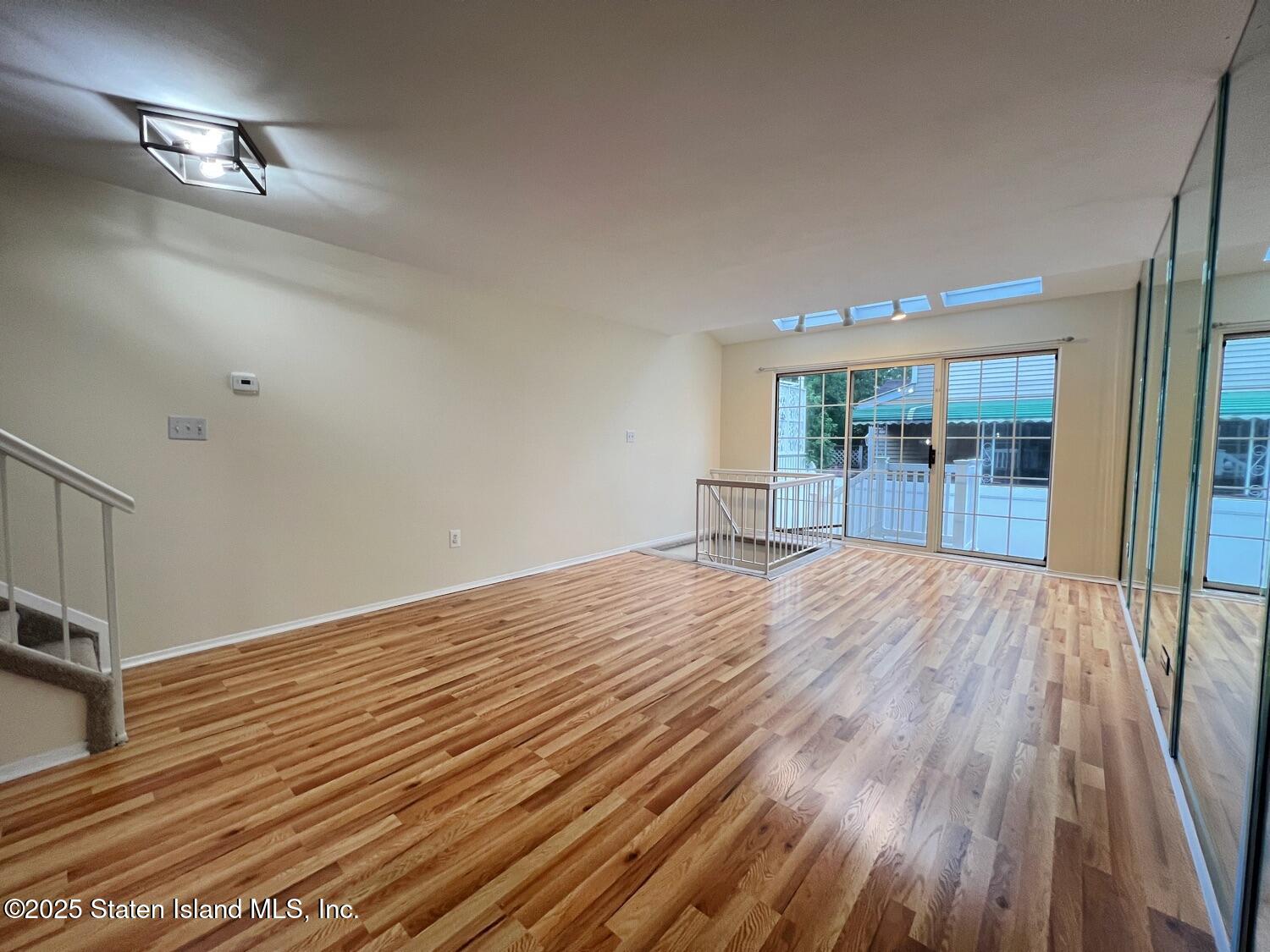 75 Chesebrough Street Staten Island, NY 10312 - Photo 6 of 32 a view of empty room with wooden floor