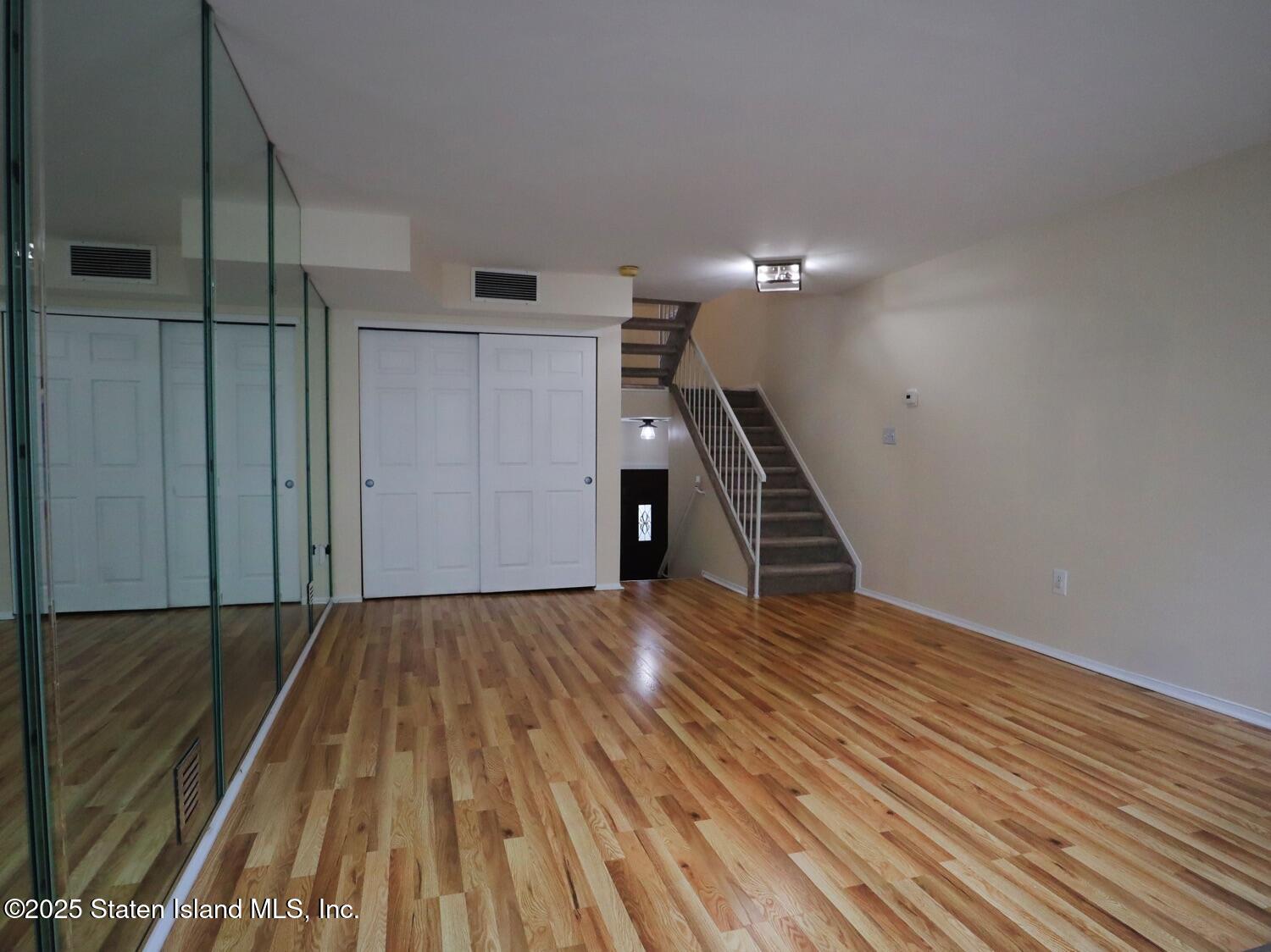 75 Chesebrough Street Staten Island, NY 10312 - Photo 7 of 32 a view of empty room with wooden floor