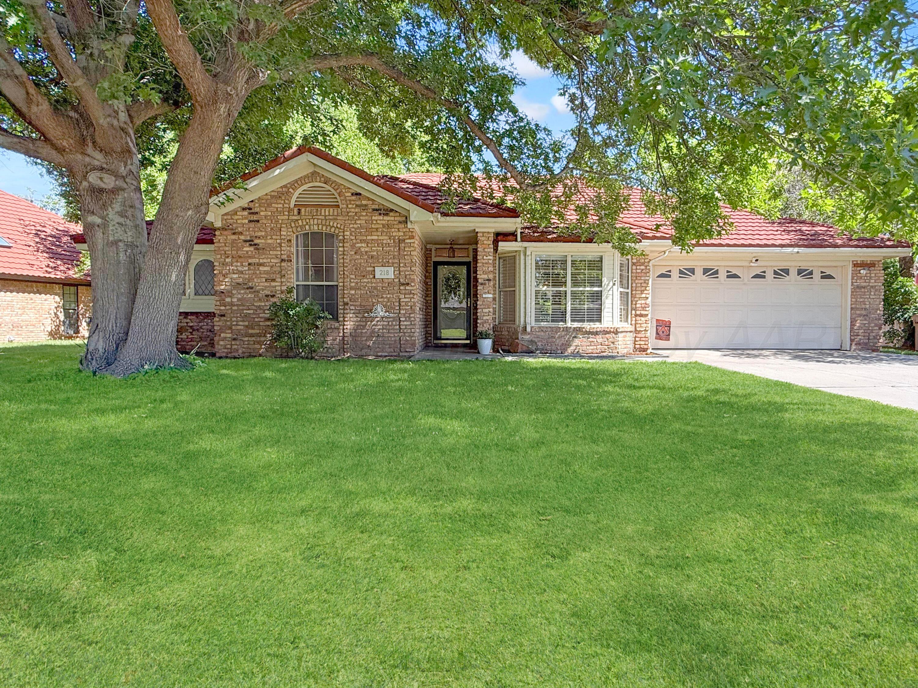 218 West Ocla Street Borger, TX 79007 - Photo 1 of 37 a front view of a house with a yard and trees