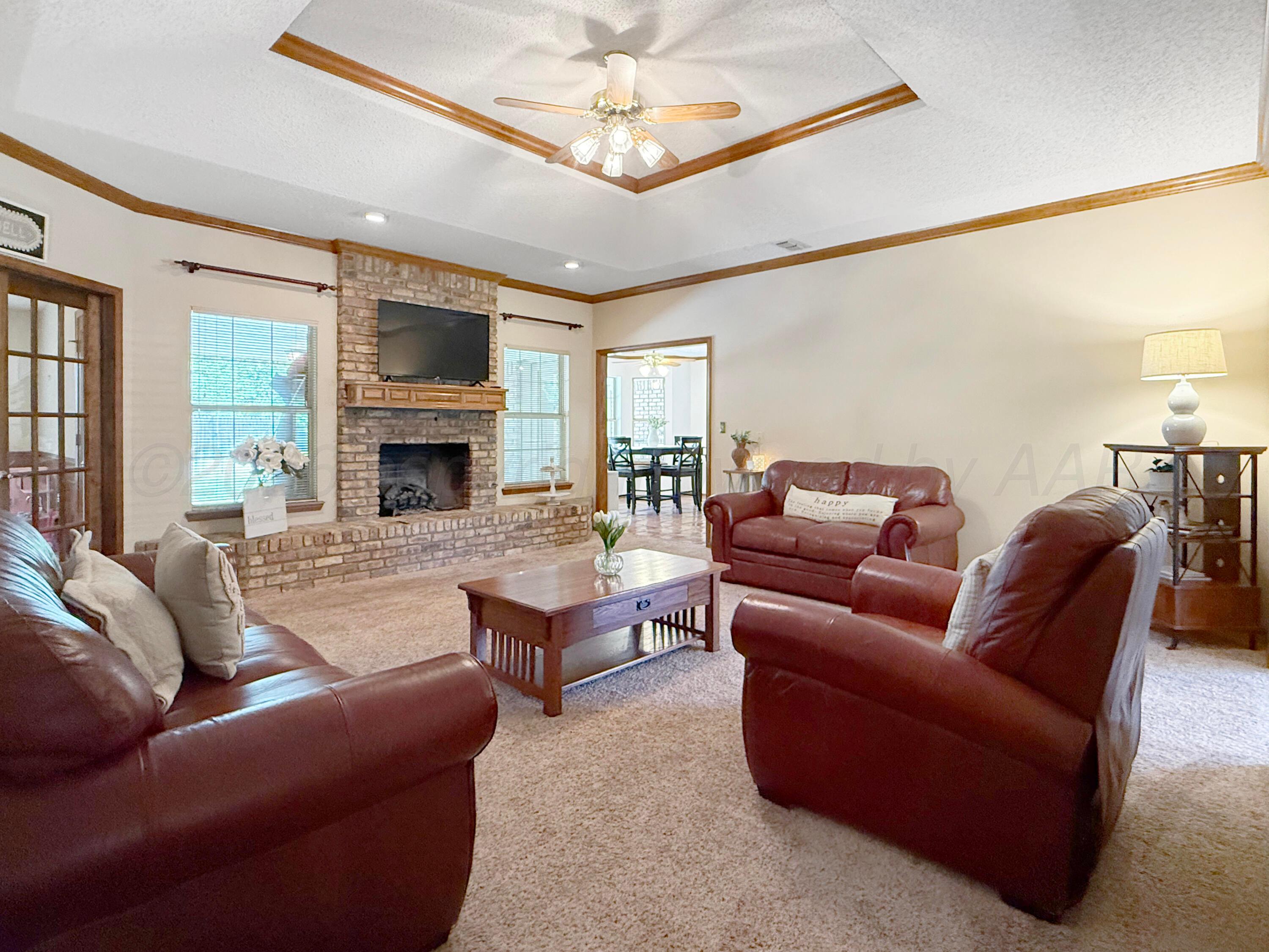 218 West Ocla Street Borger, TX 79007 - Photo 14 of 37 a living room with furniture a fireplace and a chandelier