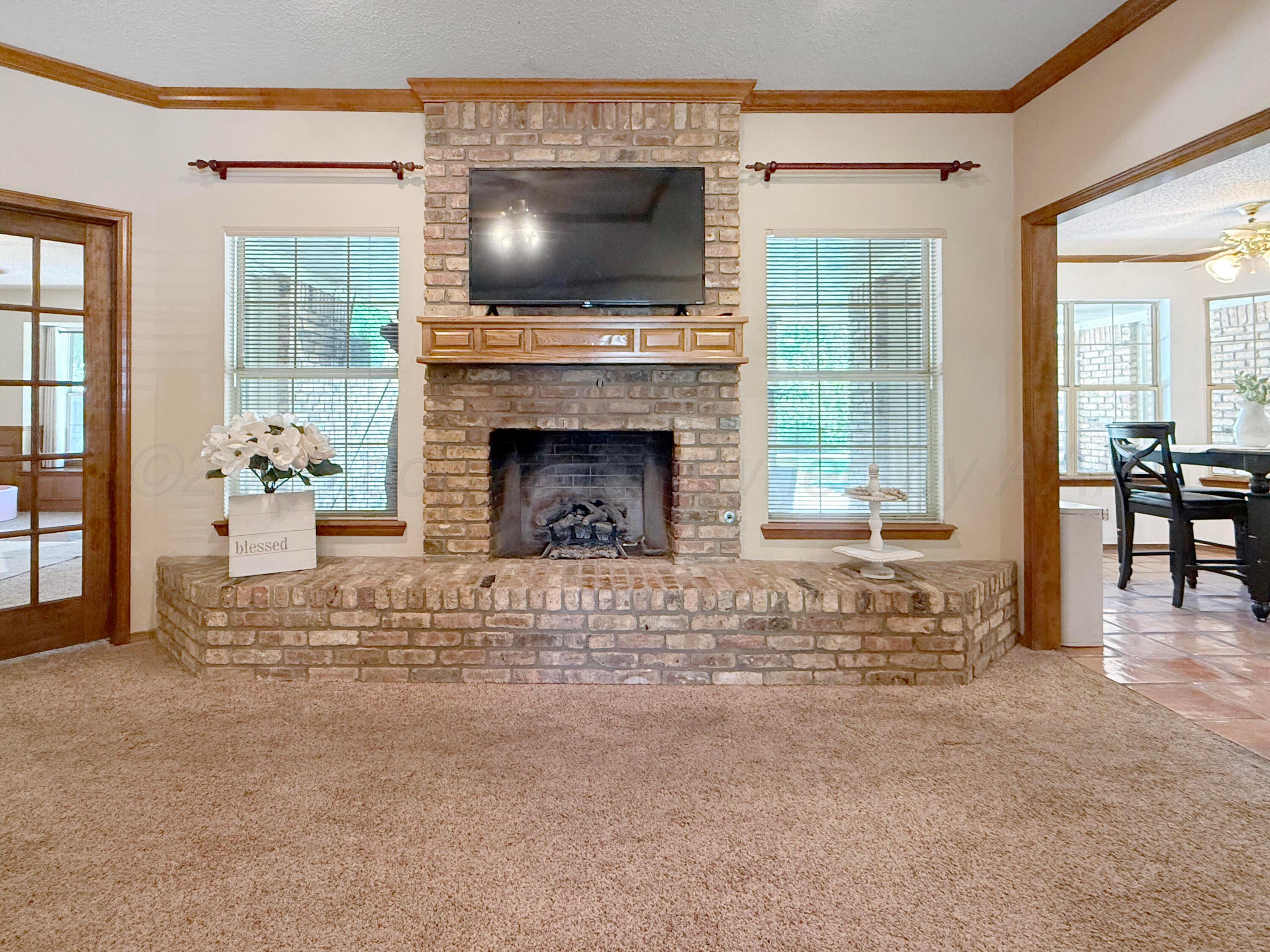 218 West Ocla Street Borger, TX 79007 - Photo 15 of 37 a living room with furniture a flat screen tv and a fireplace
