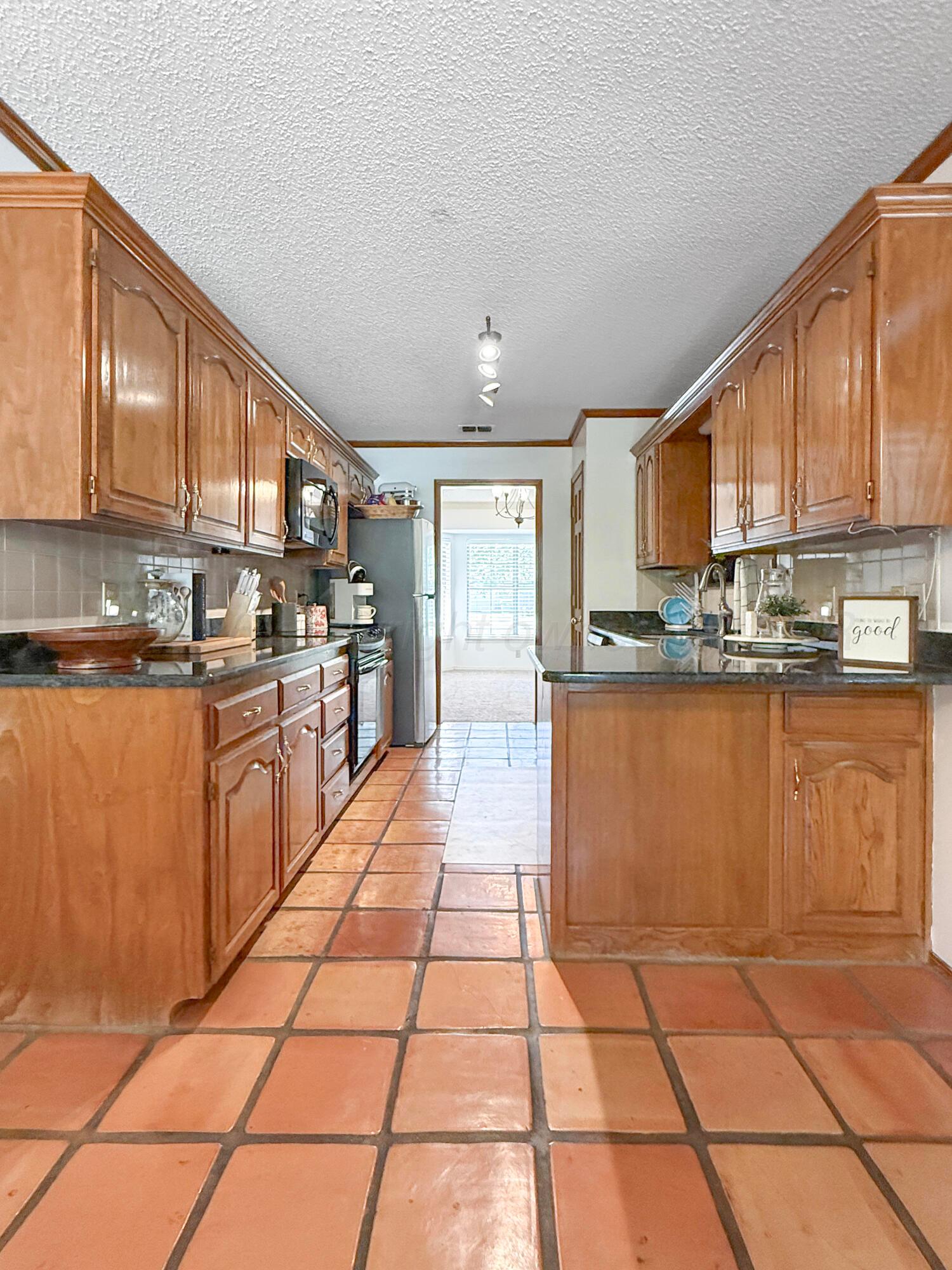 218 West Ocla Street Borger, TX 79007 - Photo 17 of 37 a kitchen with stainless steel appliances granite countertop a stove a sink a microwave and cabinets