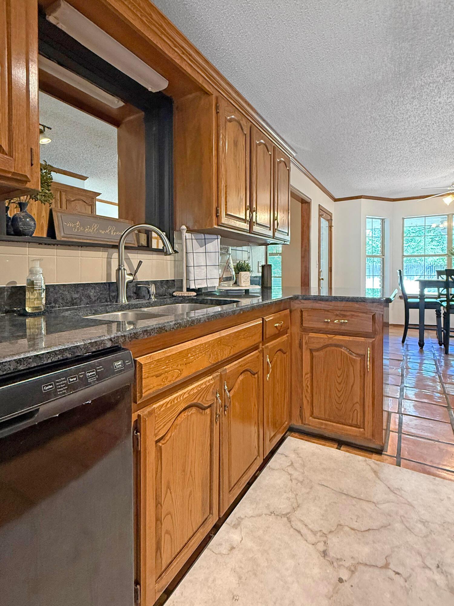 218 West Ocla Street Borger, TX 79007 - Photo 18 of 37 a kitchen with stainless steel appliances granite countertop a stove sink and cabinets