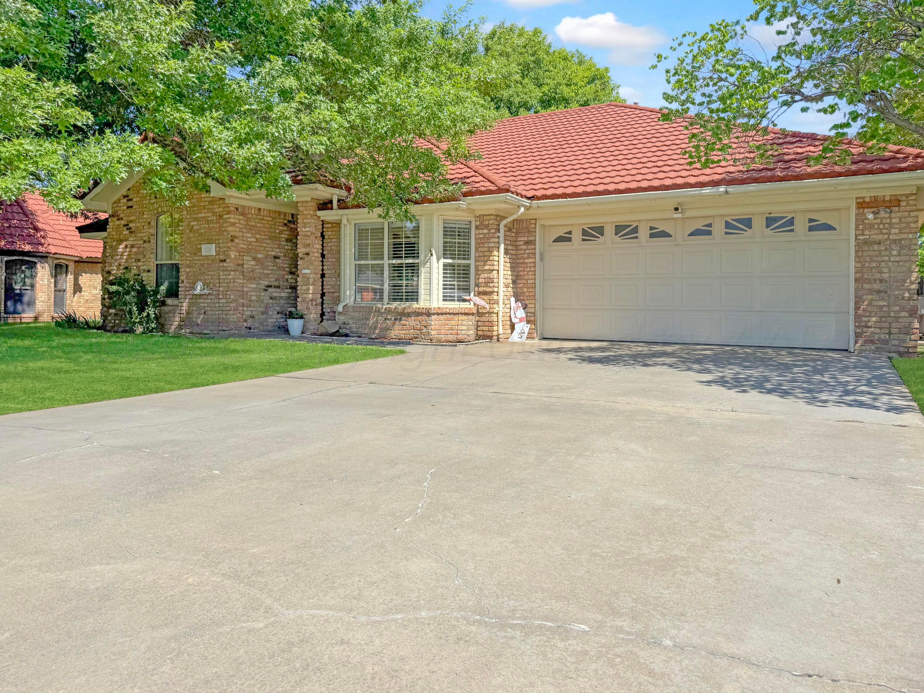 218 West Ocla Street Borger, TX 79007 - Photo 2 of 37 a view of a house with a yard and garage
