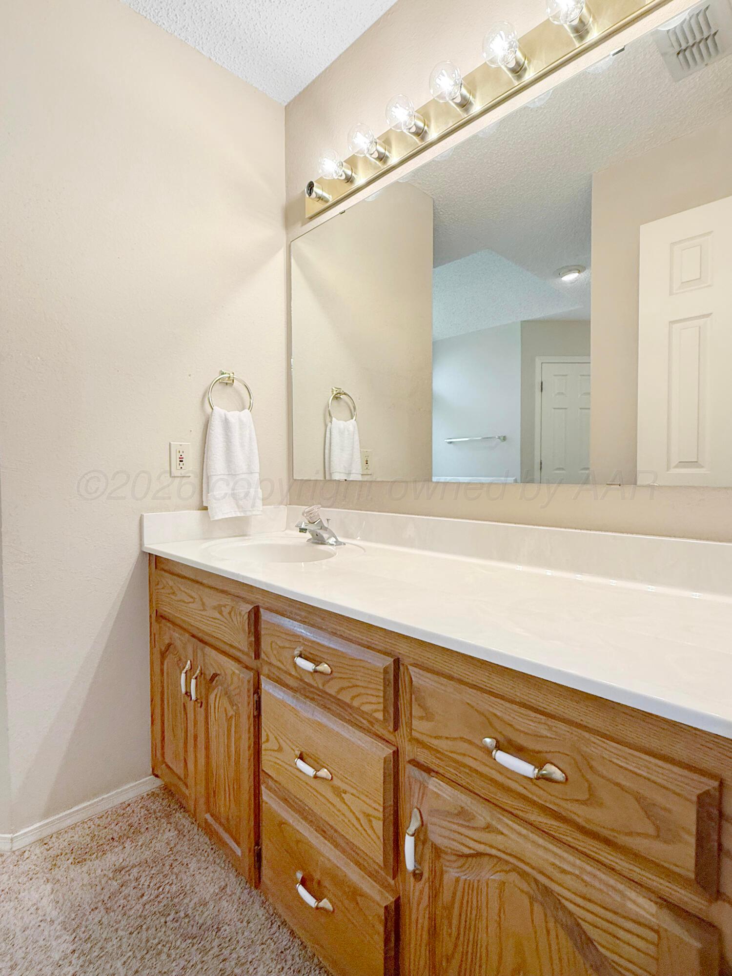 218 West Ocla Street Borger, TX 79007 - Photo 23 of 37 a bathroom with a sink and a mirror
