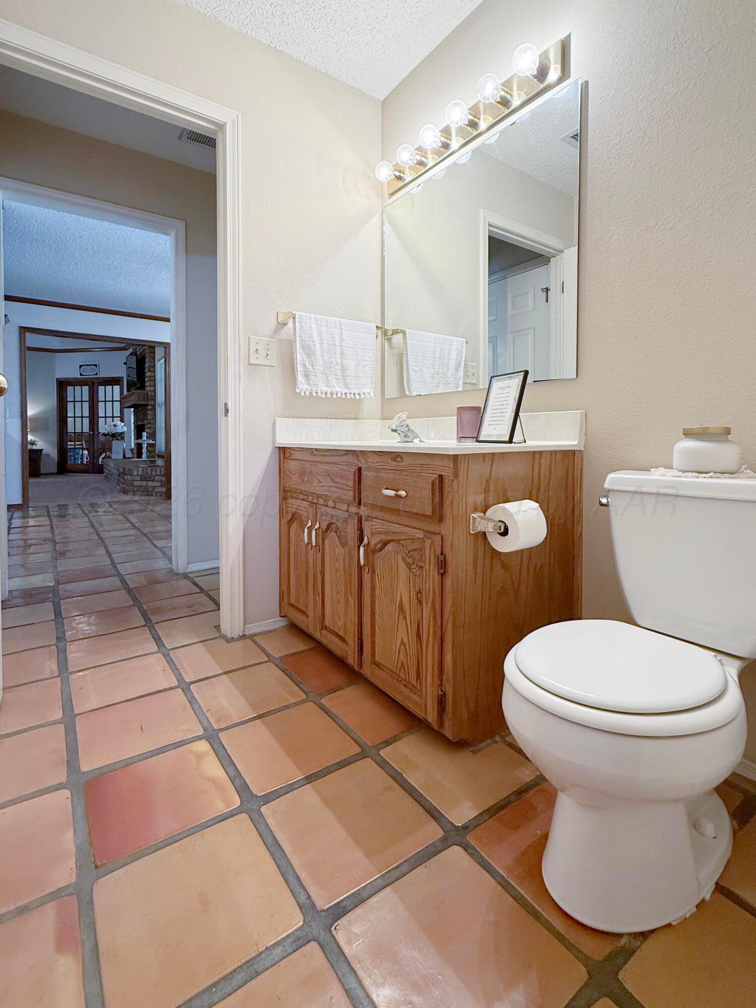 218 West Ocla Street Borger, TX 79007 - Photo 28 of 37 a bathroom with a sink toilet and mirror