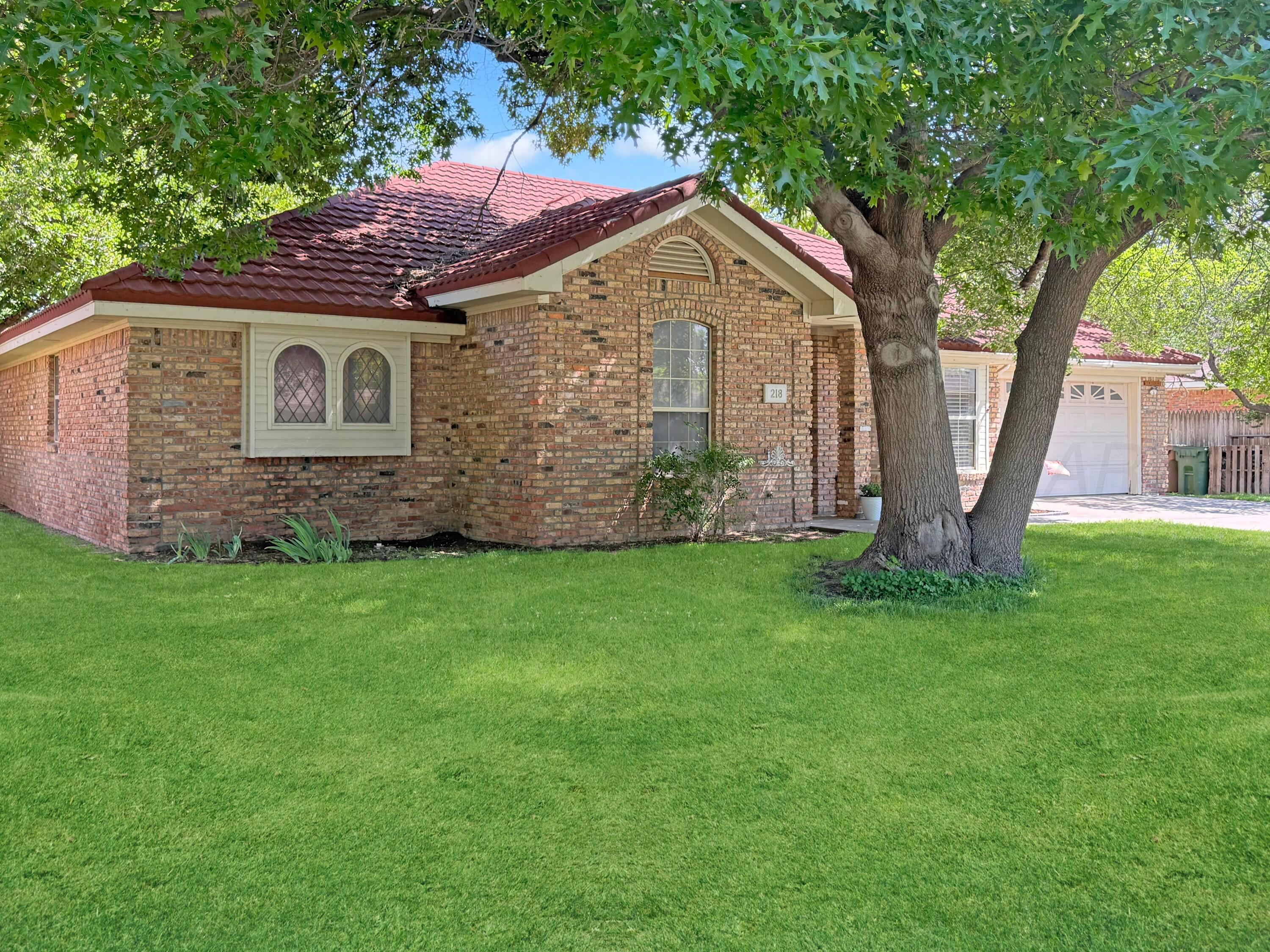 218 West Ocla Street Borger, TX 79007 - Photo 3 of 37 a front view of a house with garden