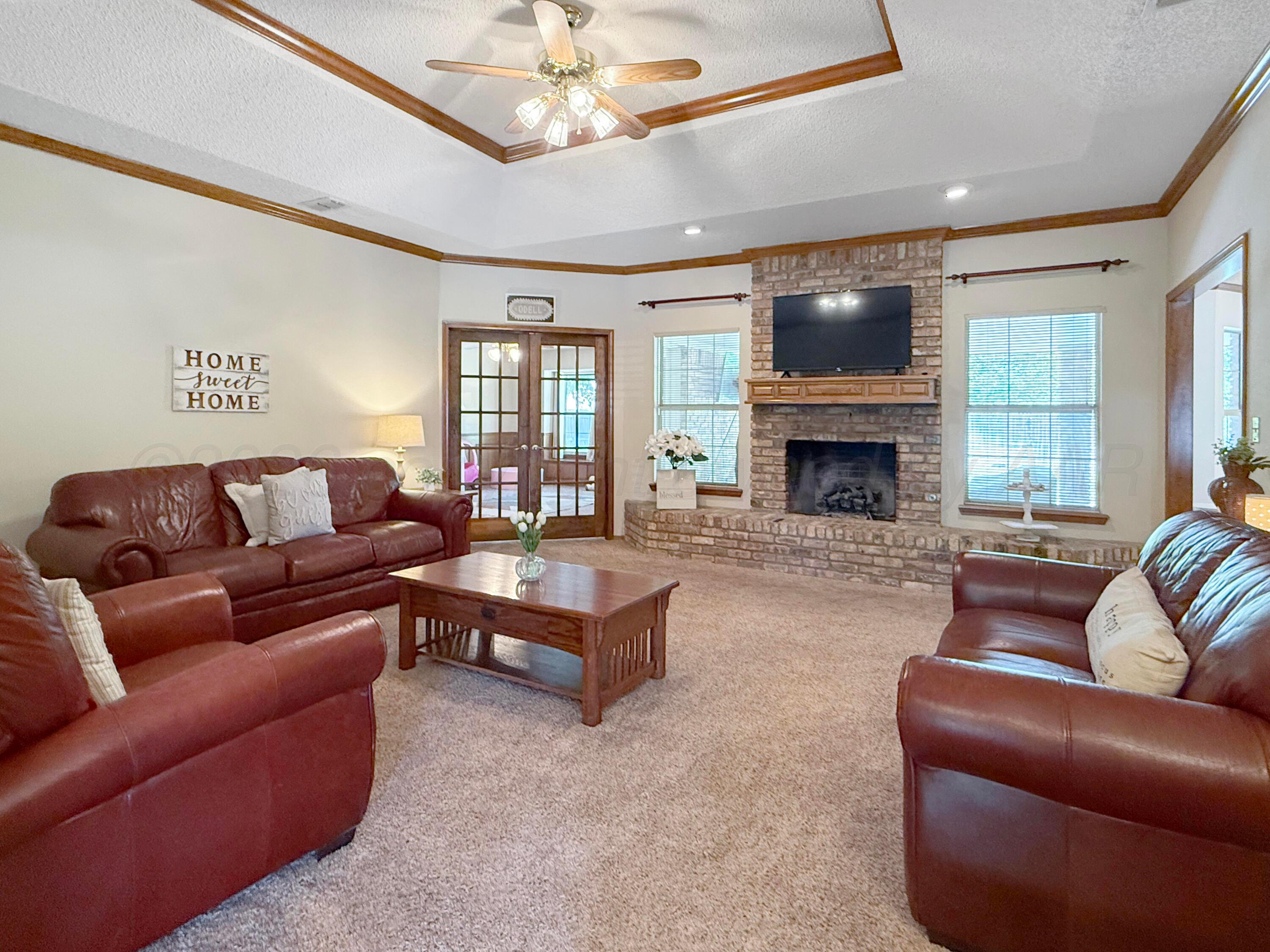 218 West Ocla Street Borger, TX 79007 - Photo 7 of 37 a living room with furniture a chandelier and a fireplace