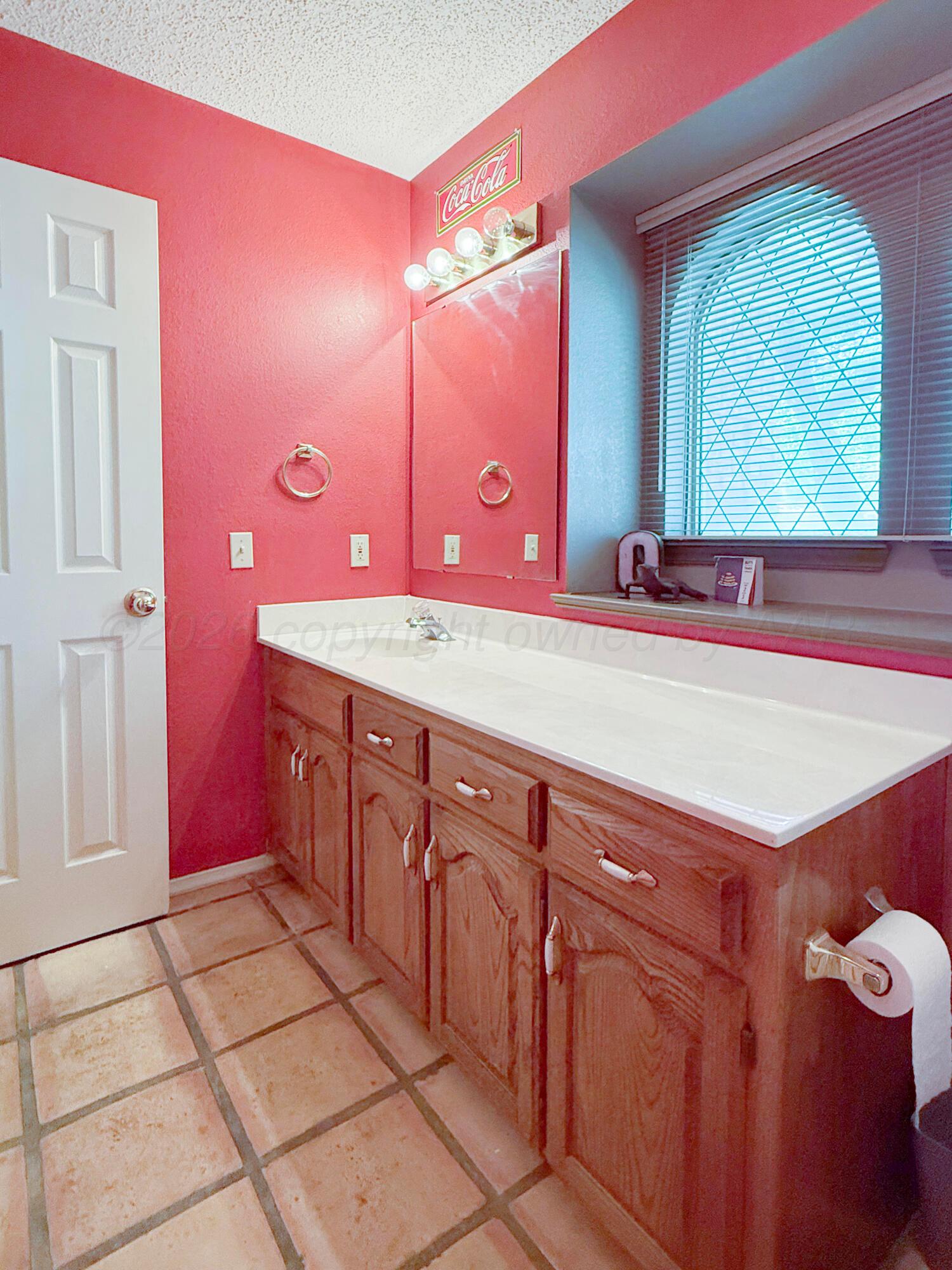 218 West Ocla Street Borger, TX 79007 - Photo 10 of 37 a bathroom with a sink a vanity and a mirror