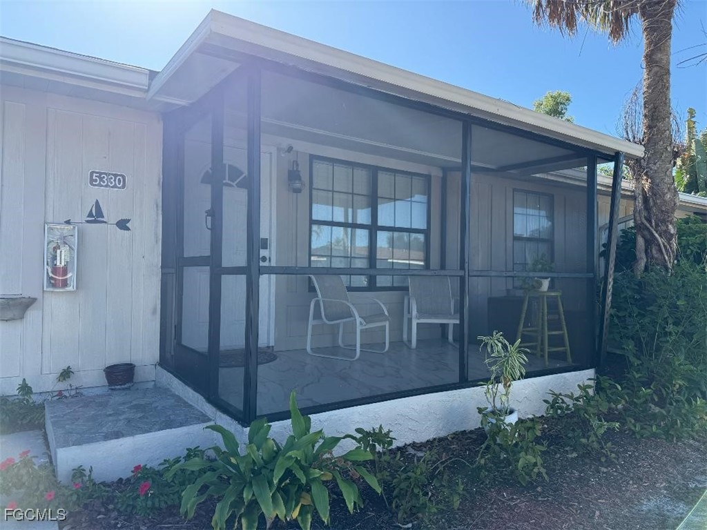 5330 Treetops Drive, Unit F4 Naples, FL 34113 - Photo 1 of 9 a view of a backyard with plants