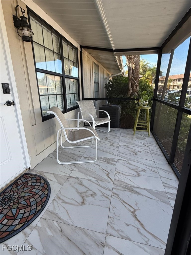 5330 Treetops Drive, Unit F4 Naples, FL 34113 - Photo 2 of 9 a view of a porch with furniture