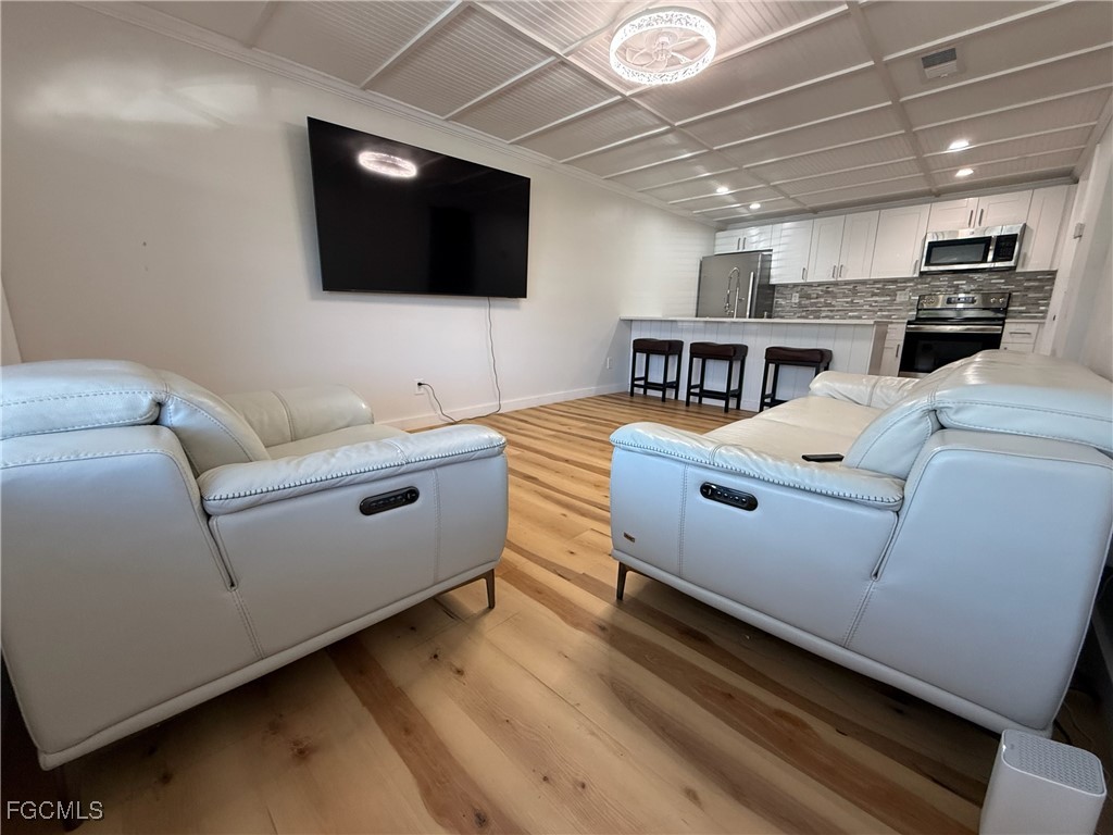 5330 Treetops Drive, Unit F4 Naples, FL 34113 - Photo 3 of 9 a living room with furniture and a flat screen tv