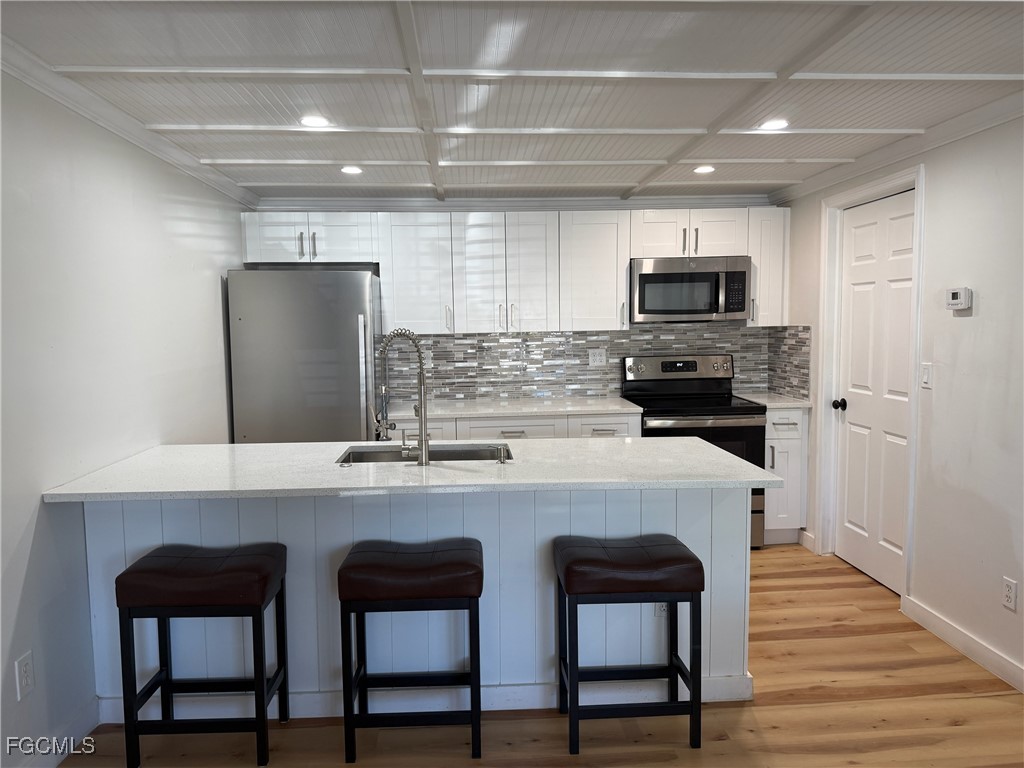 5330 Treetops Drive, Unit F4 Naples, FL 34113 - Photo 4 of 9 a kitchen with appliances cabinets and furniture