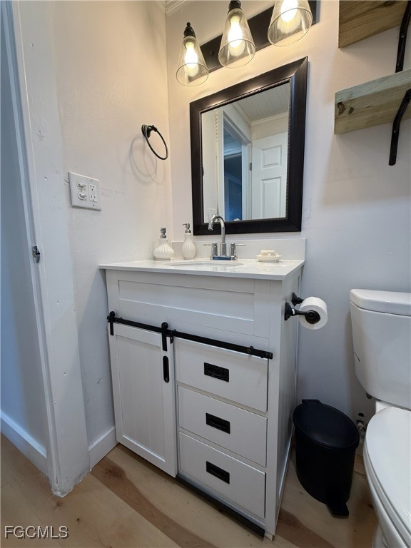5330 Treetops Drive, Unit F4 Naples, FL 34113 - Photo 7 of 9 a bathroom with a toilet a sink and mirror