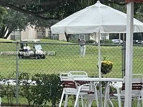 a view of a table and chairs under an umbrella