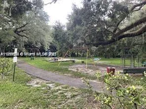 a view of street with large trees