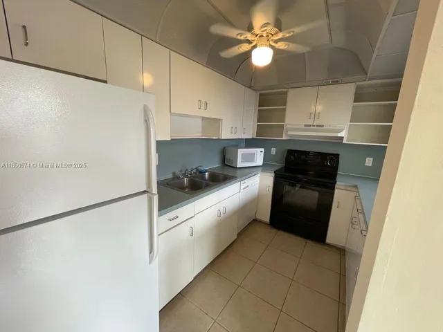 a kitchen with stainless steel appliances a refrigerator sink and cabinets