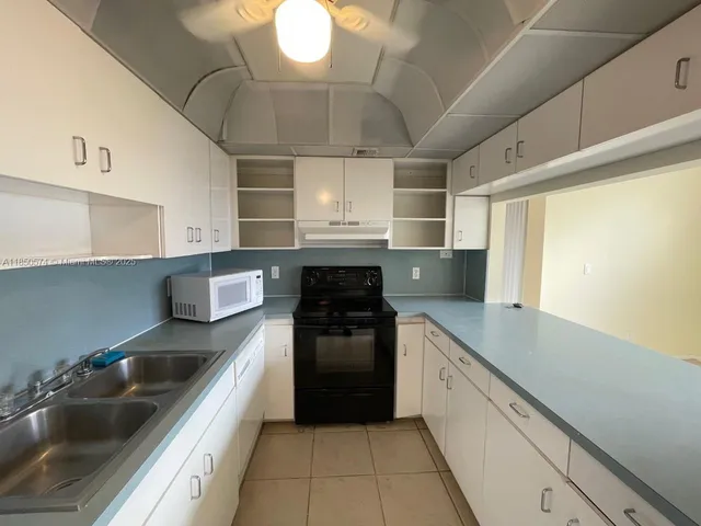 a kitchen with a sink cabinets and stainless steel appliances