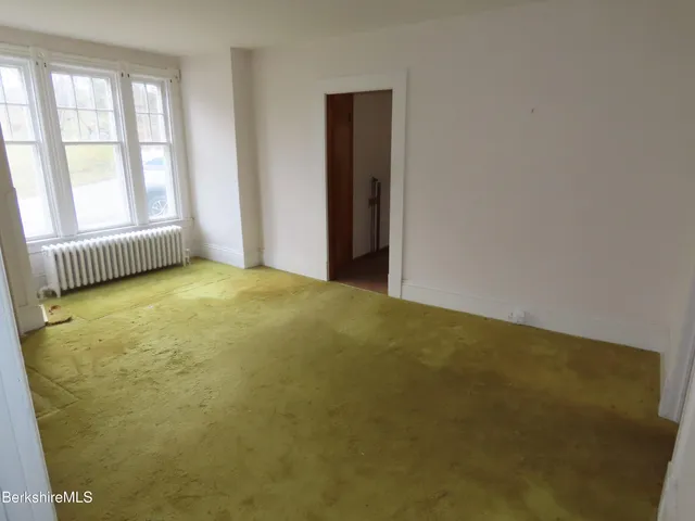 an empty room with floor to ceiling windows