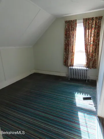 a view of room with window and wooden floor