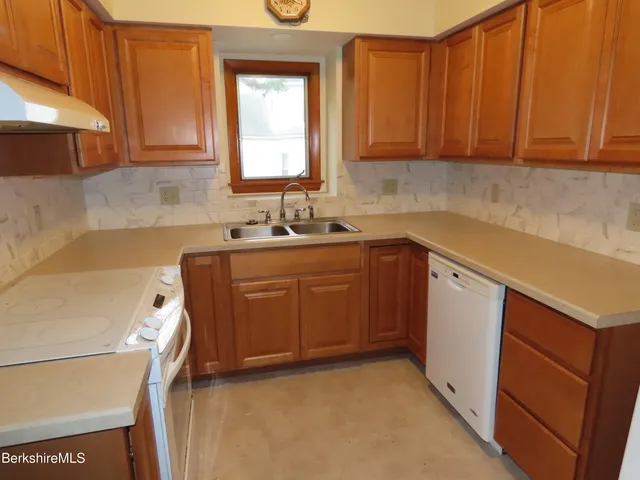a utility room with sink dryer and washer