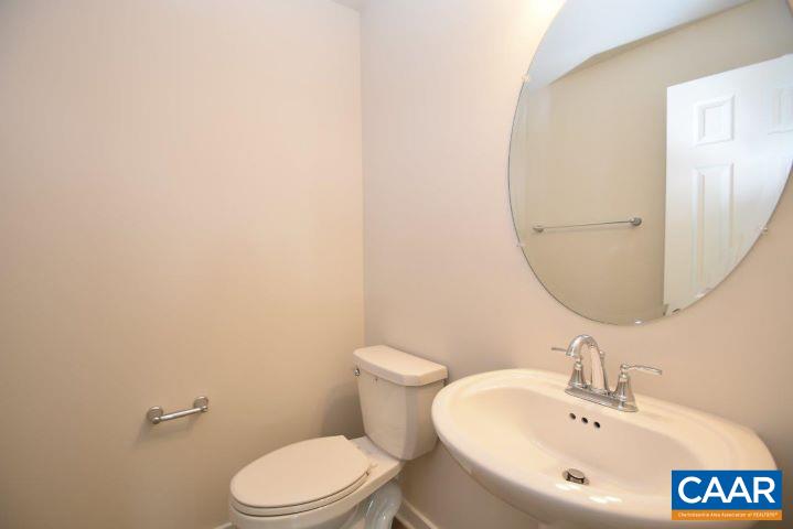 182 Riva Way Palmyra, VA 22963 - Photo 14 of 25 a white toilet sitting next to a bathroom sink