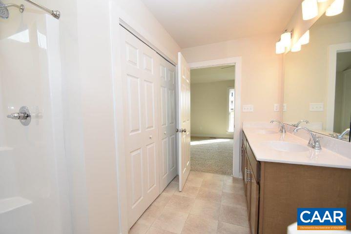 182 Riva Way Palmyra, VA 22963 - Photo 19 of 25 a en suite bathroom with a granite countertop sink and a mirror