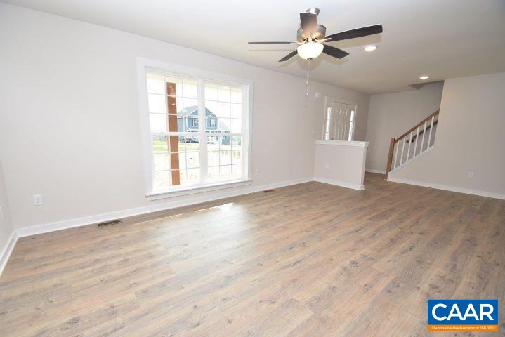 182 Riva Way Palmyra, VA 22963 - Photo 4 of 25 a view of an empty room with a window and wooden floor