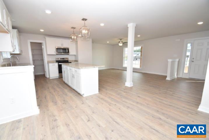 182 Riva Way Palmyra, VA 22963 - Photo 8 of 25 a open kitchen with white cabinets and stainless steel appliances