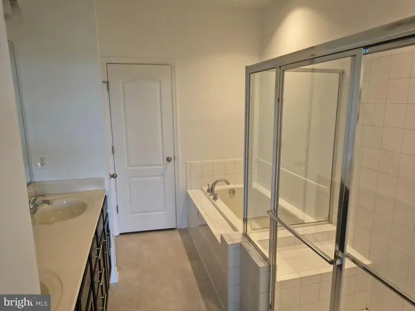 a bathroom with a tub and shower