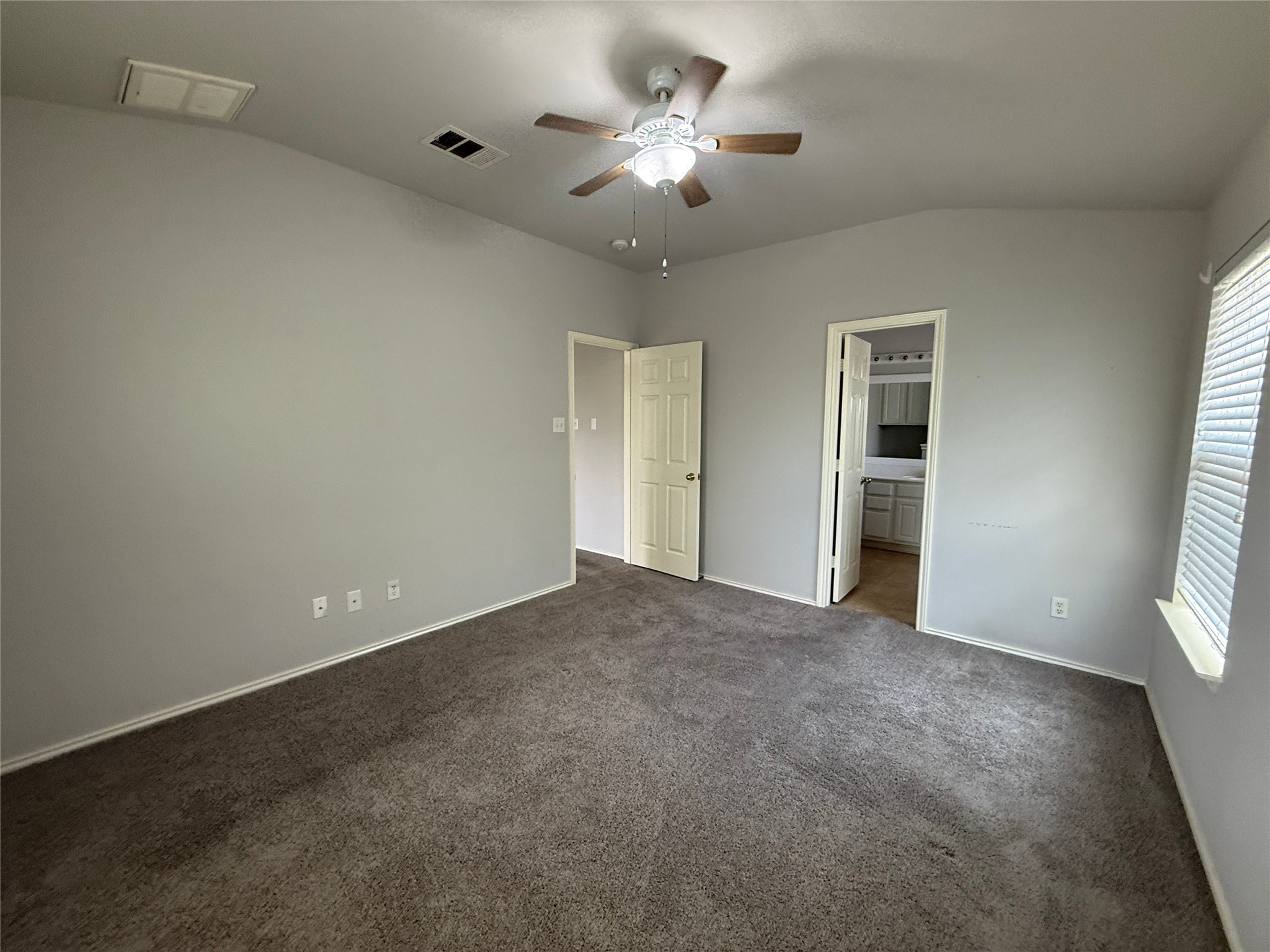 1900 Scofield Ridge Parkway, Unit 4701 Austin, TX 78727 - Photo 7 of 27 A comfortable bedroom features carpet flooring and a refreshing ceiling fan.