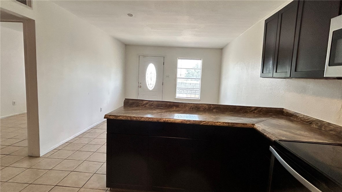1004 Austin Street, Unit 9 Portland, TX 78374 - Photo 10 of 22 Kitchen and bar area overlook the living room