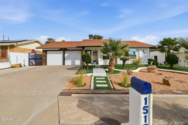 a view of a white house with table and chairs