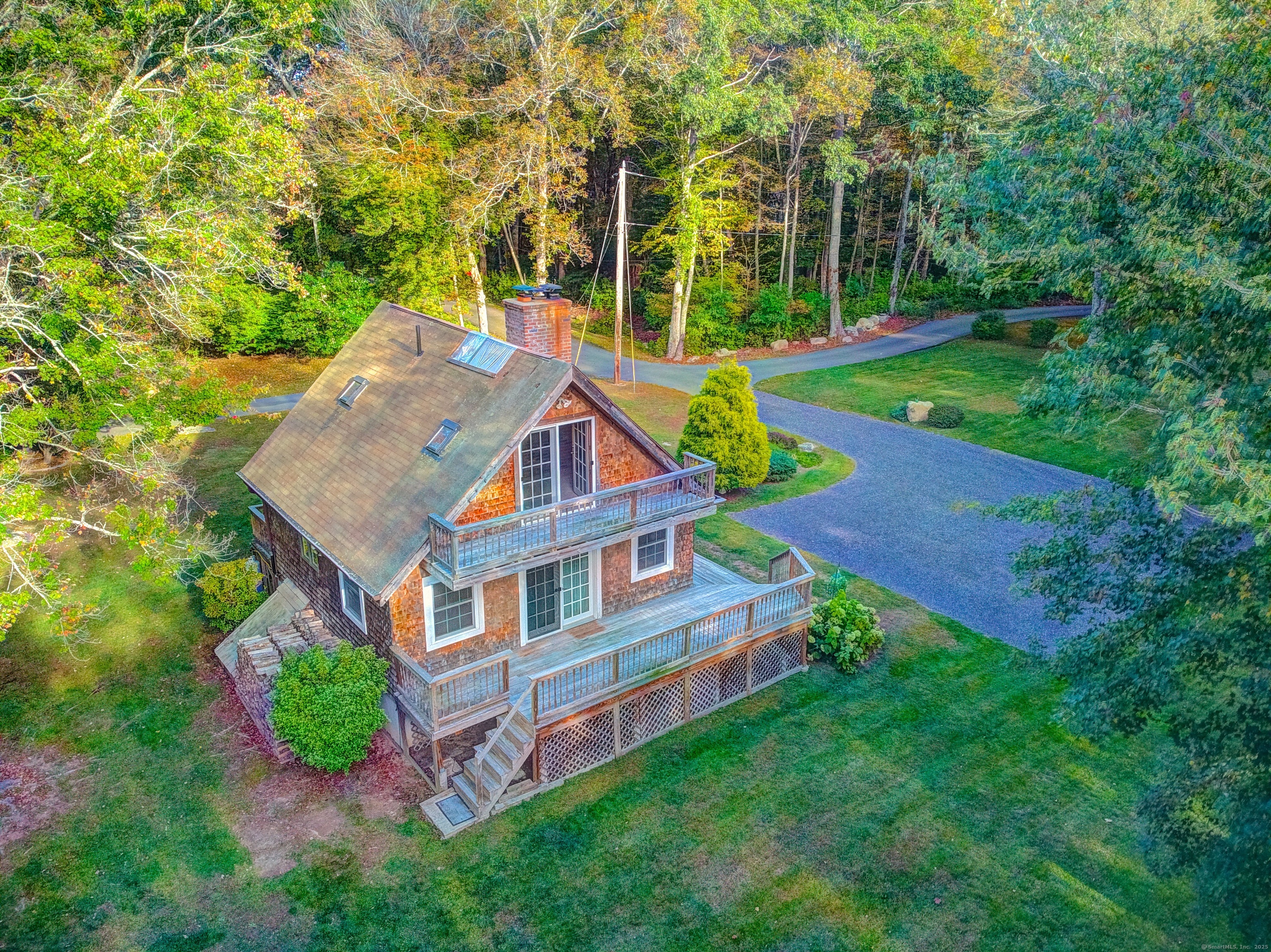 an aerial view of a house with swimming pool next to a big yard
