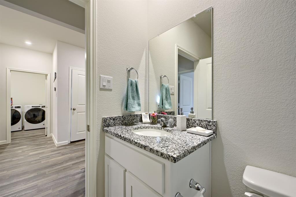 420 Jameson Springtown, TX 76082 - Photo 22 of 29 a bathroom with a granite countertop sink and a mirror