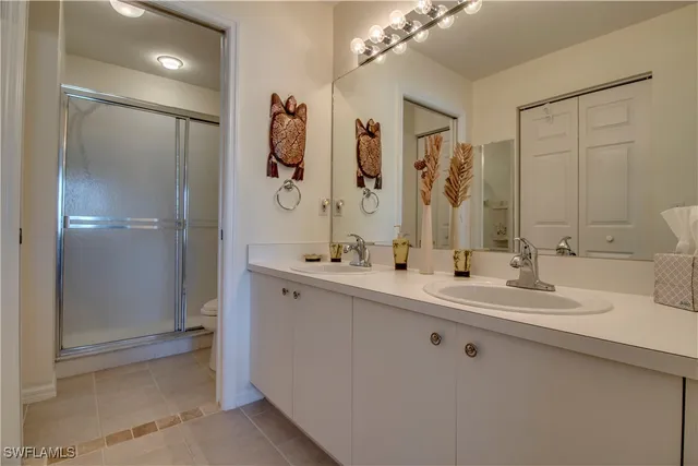 a bathroom with a double vanity sink mirror and double