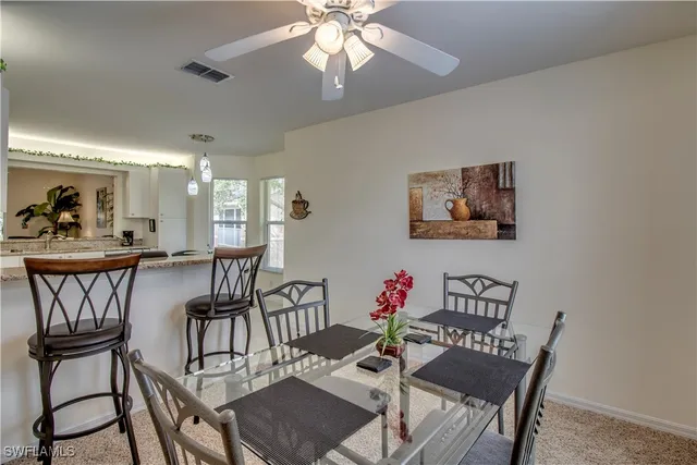 a view of a dining room with furniture and a chandelier