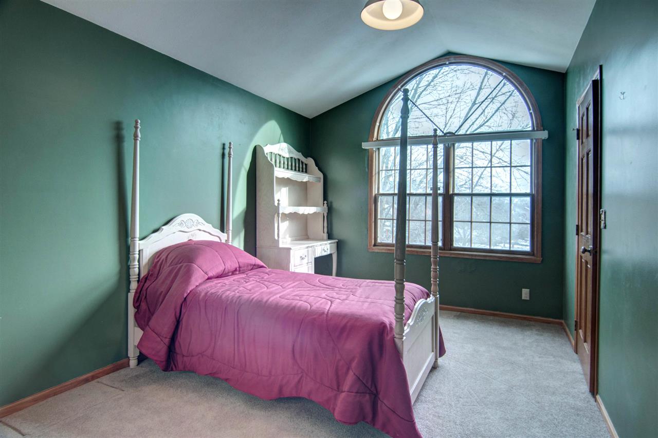7196 Sentinel Road Rockford, IL 61107 - Photo 14 of 24 a bedroom with a bed and a large window